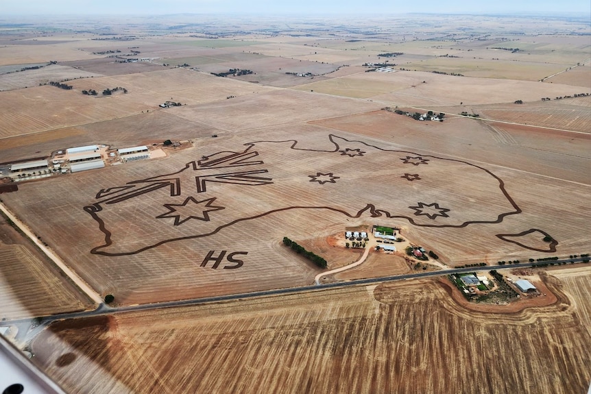 Aerial photo of a map of Australia with flag in WA top corner marked on paddock with homestead 