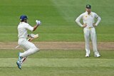 India's Virat Kohli (L) celebrates as century as Australia's Steve Smith looks on at the MCG.