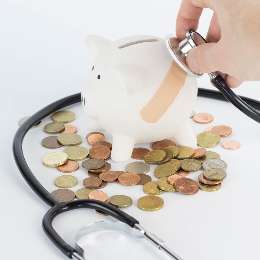 stethoscope with piggybank coins and bandage generic stock