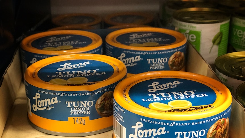 Cans of vegan tuna in a supermarket.