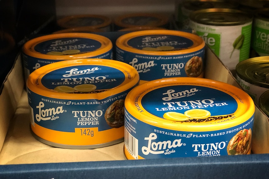 Cans of vegan tuna in a supermarket.