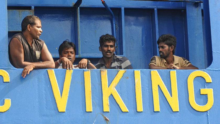 Sri Lankan asylum seekers stand on the deck of the Oceanic Viking