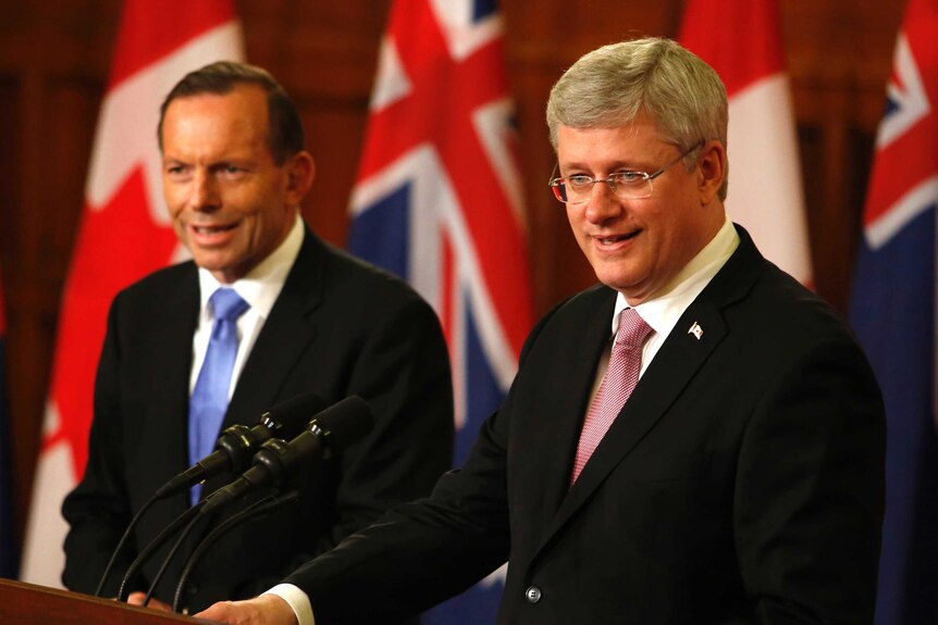 LtoR Prime Minister Tony Abbott and Canada's Prime Minister Stephen Harper hold a joint news conference.