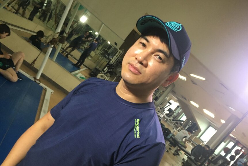 Coach Jae-Su Chun stands in a Seoul training area, looking directly at the camera.
