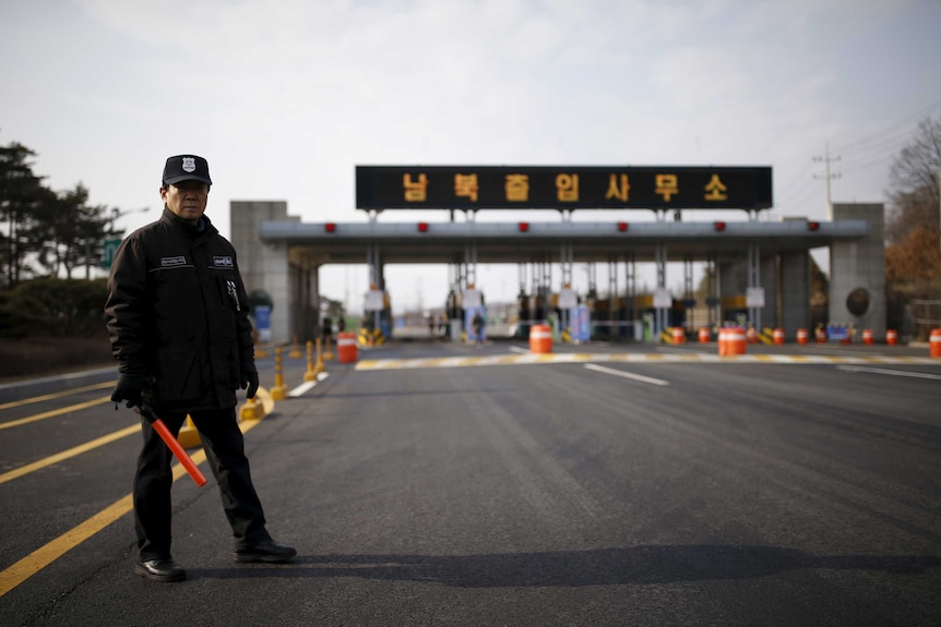 A South Korean security guard stands guard on an empty road leading to the Kaesong Industrial Complex