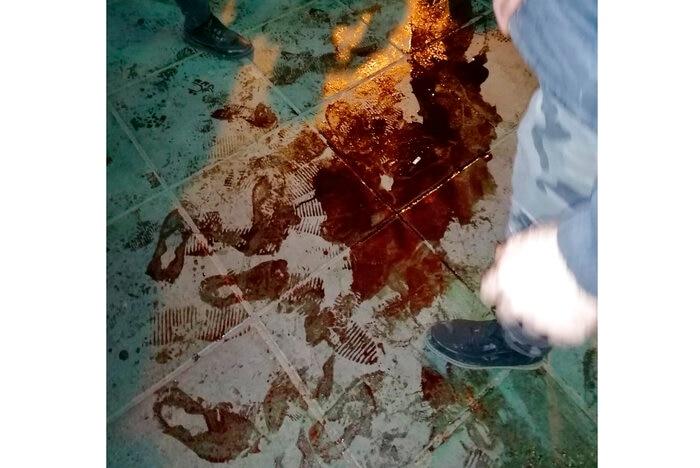 Blood is seen on the floor among footsteps and protesters feet.