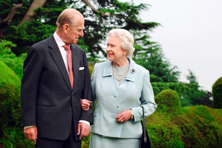 Queen Elizabeth and Prince Philip, the Duke of Edinburgh, walk at Broadlands in Romsey.