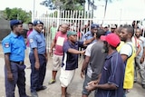 PNG police facing angry men.