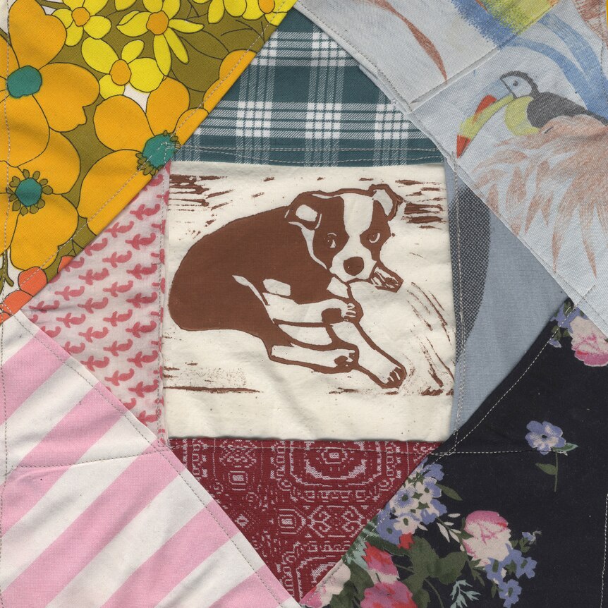 tapestry quilt featuring a path of a dog in its centre