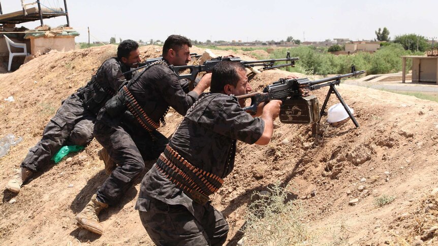 Kurdish security forces take their positions during clashes with ISIS in Kirkuk