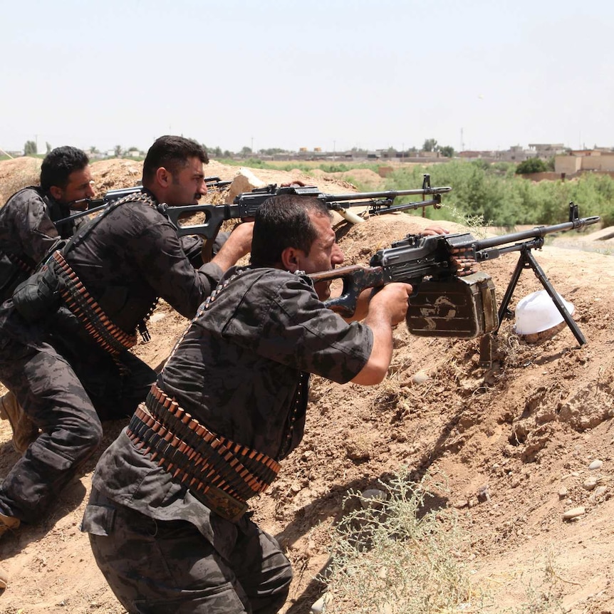 Kurdish security forces take their positions during clashes with ISIS in Kirkuk