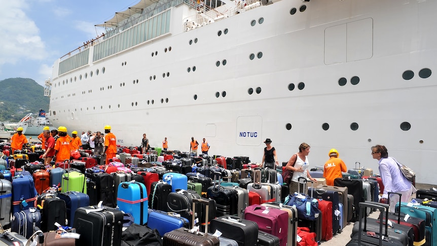 Passengers of the Costa Allegra search for their luggage