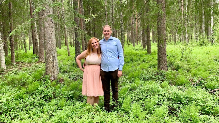 Australian woman Wendy Luttrell and her partner stand in a forest in Sweden.