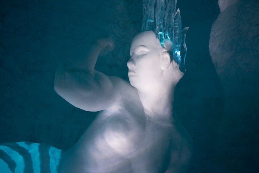 An ice sculpture of a fit mermaid