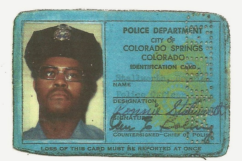 A blue ID card showing Ron Stallworth as a member of the Colorado Springs Police Department.