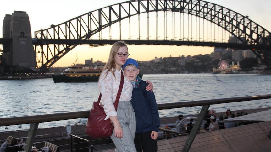 Two children in front of Sydney Harbour Bridge.