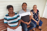 three Aboriginal elders sitting outside Cherbourg court house