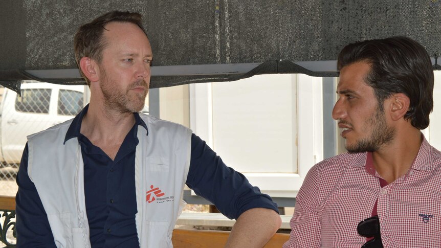 Australian psychiatrist Greg Keane talks with a colleague at the displaced persons camp in Iraq.