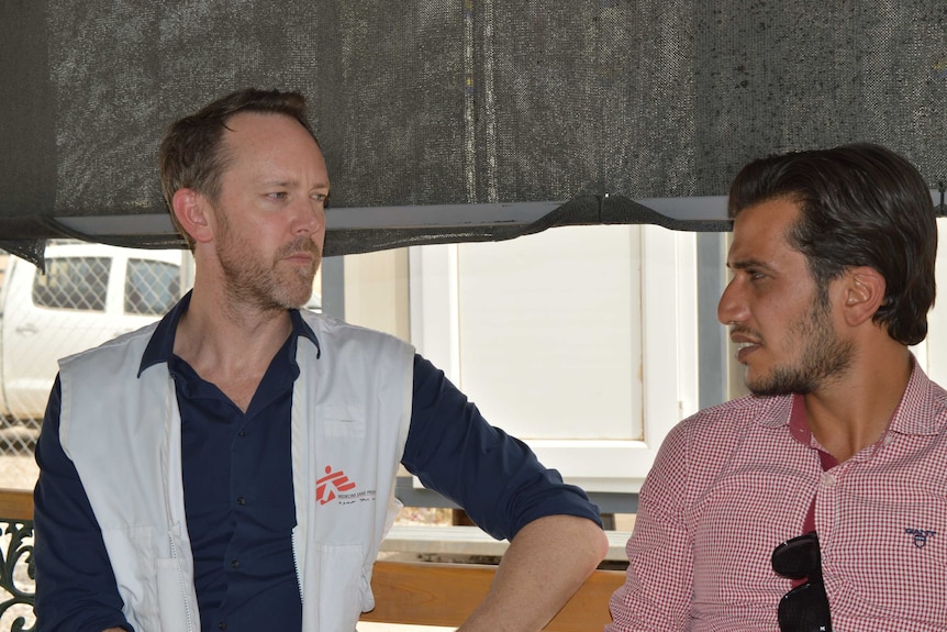 Australian psychiatrist Greg Keane talks with a colleague at the displaced persons camp in Iraq.