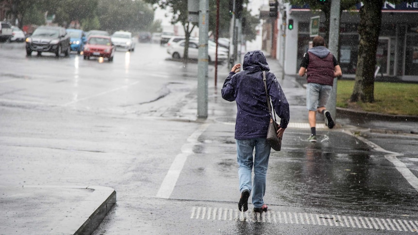 Pedestrians running to escape heavy rain in Ballarat, in central Victoria.