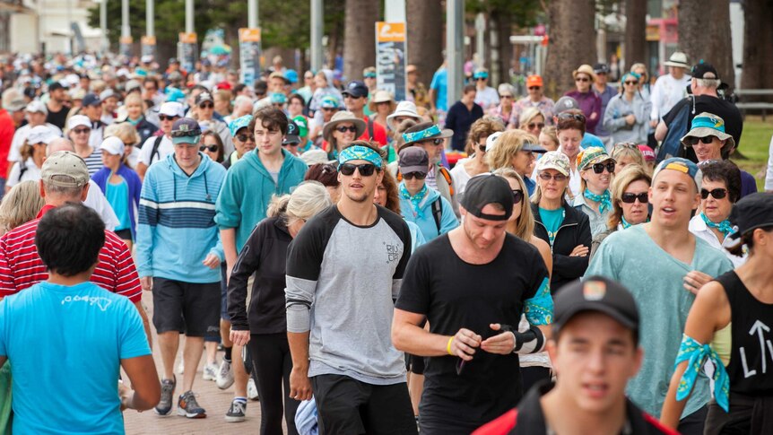 A large group of people taking part in a group walk.