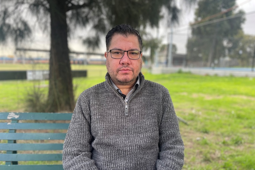 A man seated on a park bench 