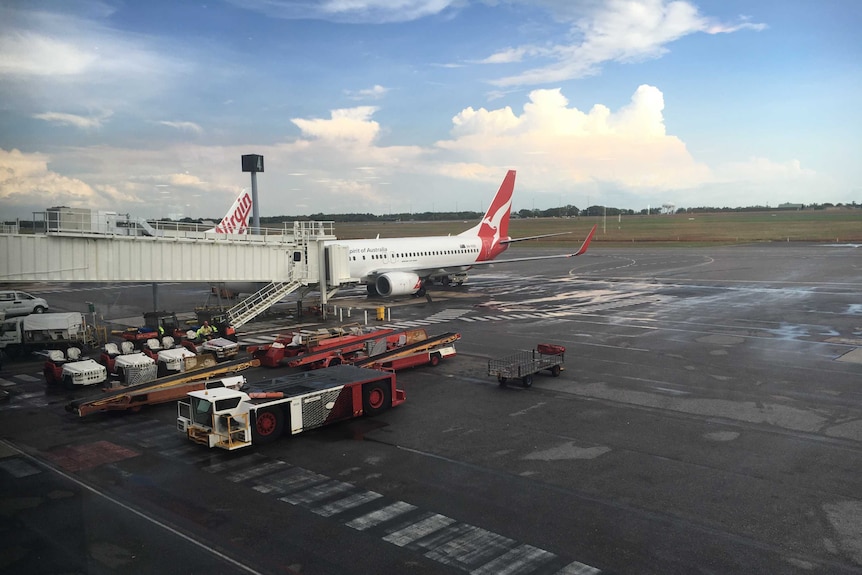 Qantas passenger plane sits on the on tarmac at Darwin International Airport