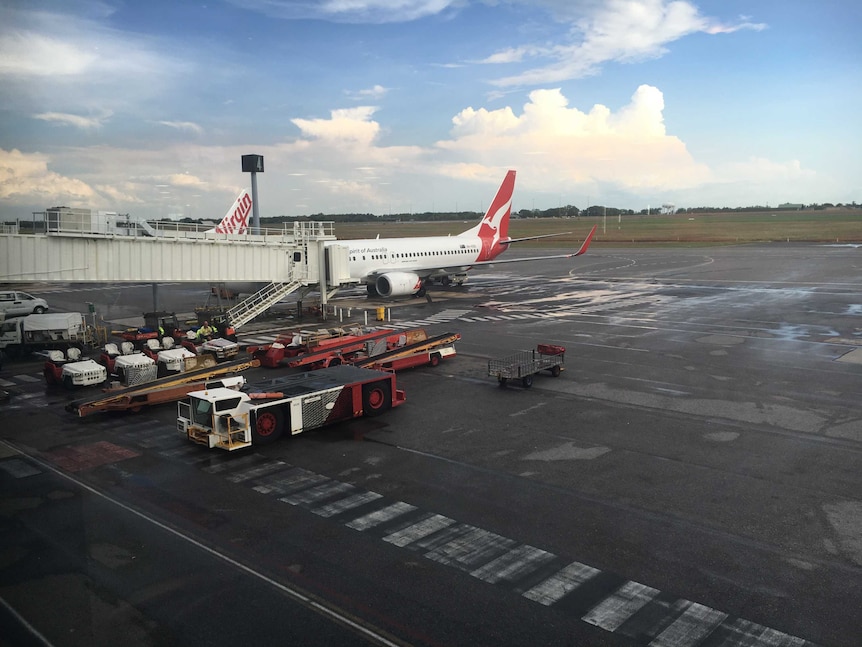 Qantas passenger plane sits on the on tarmac at Darwin International Airport