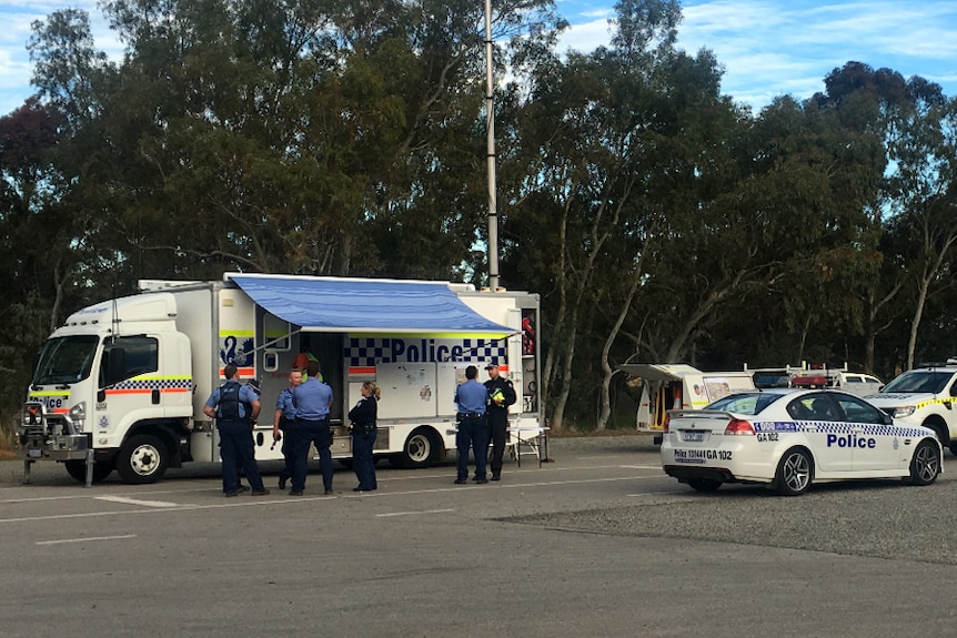 Police command post with police and emergency service vehicles.