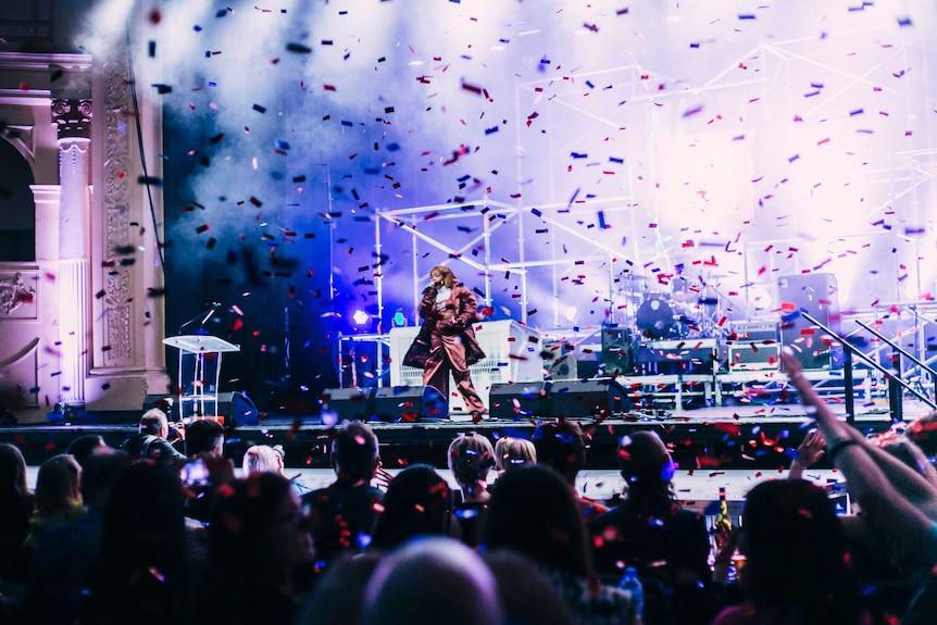 Tkay Maidza performing on stage as confetti falls into the crowd