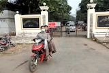 Prison staff ride a motorcycle outside Insein prison in Yangon, Myanmar.
