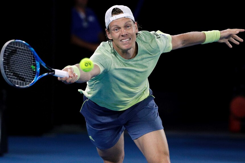 Tomas Berdych of the Czech Republic reaches for a forehand against Roger Federer.