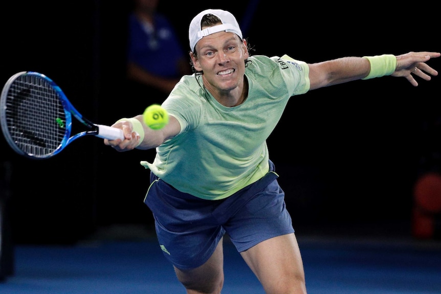 Tomas Berdych of the Czech Republic reaches for a forehand against Roger Federer.