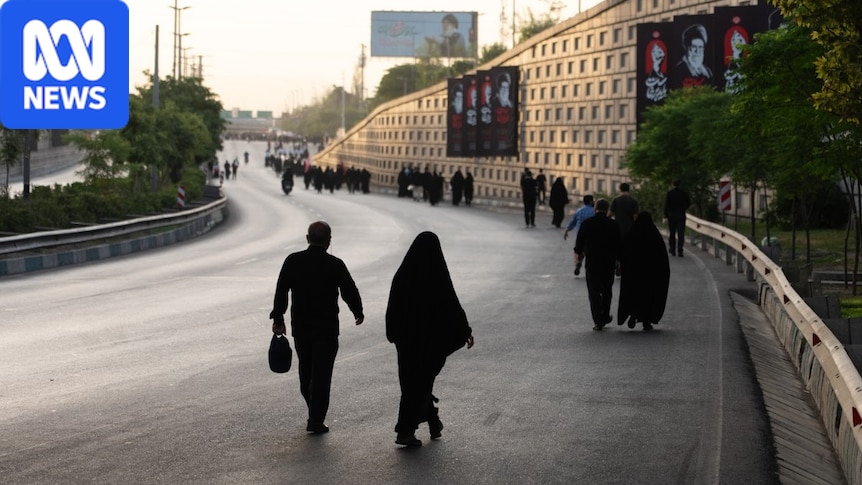 An Iranian woman seen through a city window