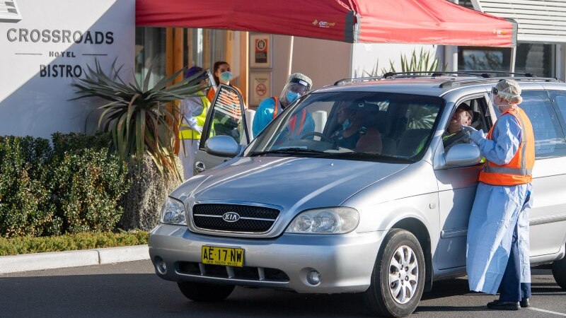 People in cars getting tested for covid-19 outside the Crossroads Hotel.