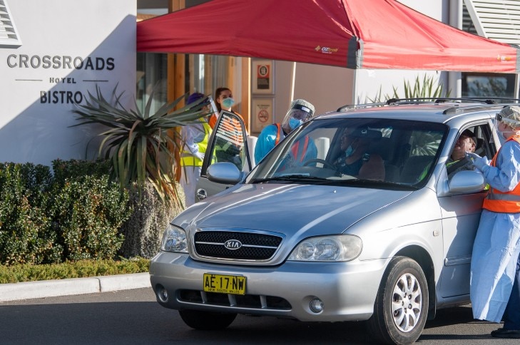 People in cars getting tested for covid-19 outside the Crossroads Hotel.