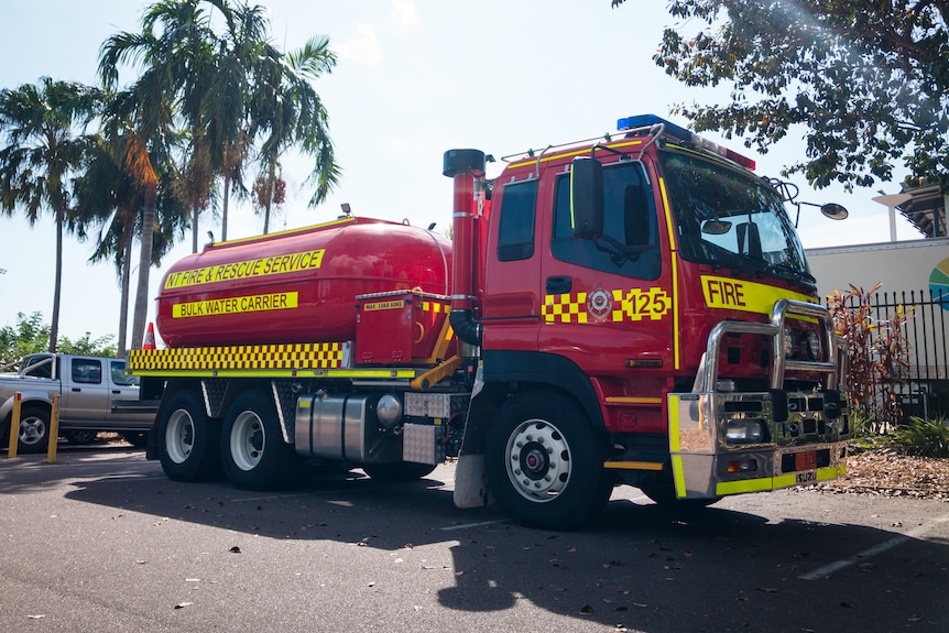 a red fire truck with a big water tank