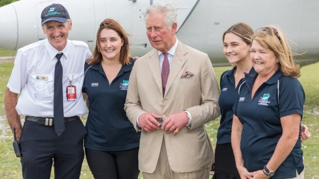 Peter Gash (left) and his wife Julie (right) with their two daughters and Prince Charles (centre).