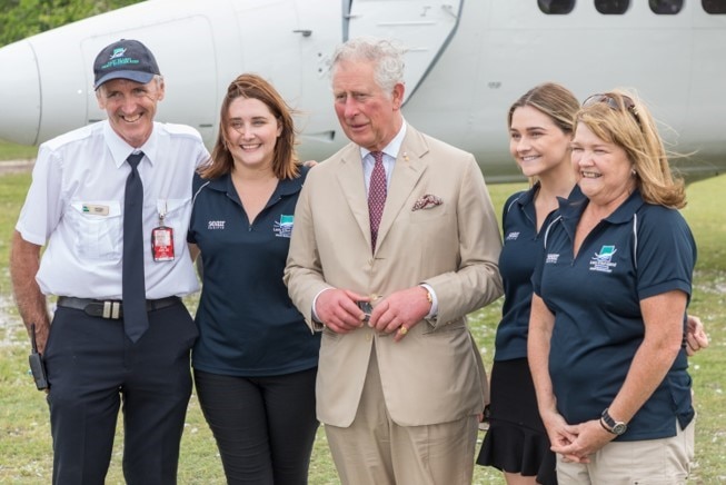 Peter Gash (left) and his wife Julie (right) with their two daughters and Prince Charles (centre).