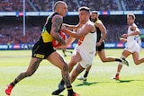 Dustin Martin gives a don't argue to a GWS player