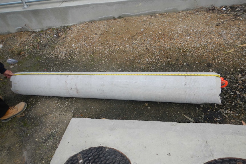 A measuring tape shows the pipe that fell was two-metres long