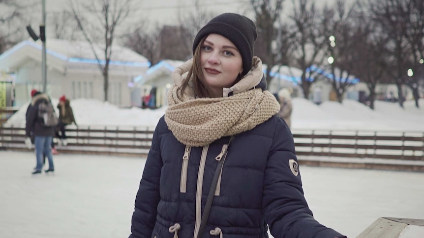 Kristina Kovalyova rugs up as she goes ice skating in the park.