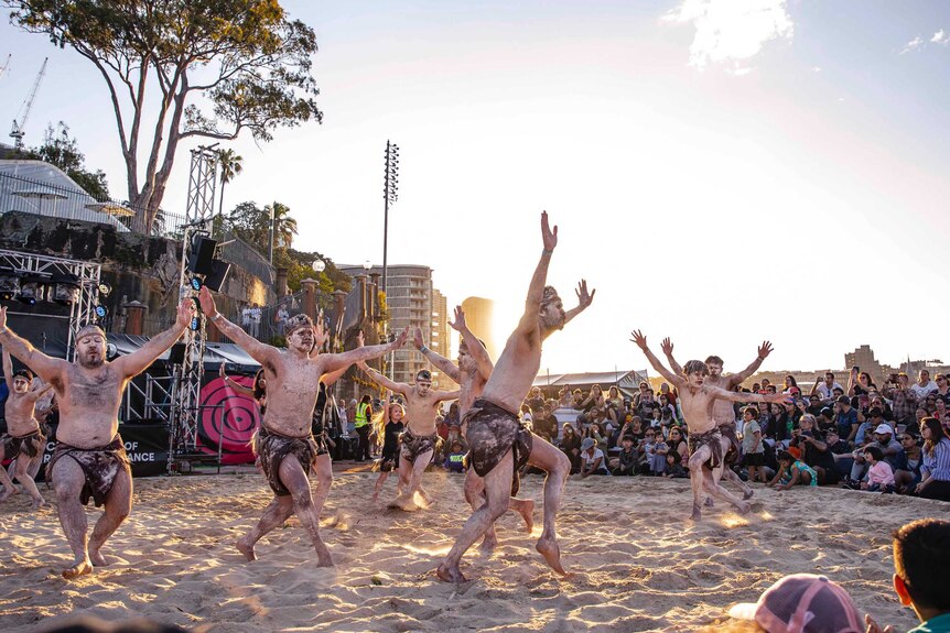 Colour photo of Thikkabilla Vibrations performing at sun down in sand circle at Dance Rites 2018.