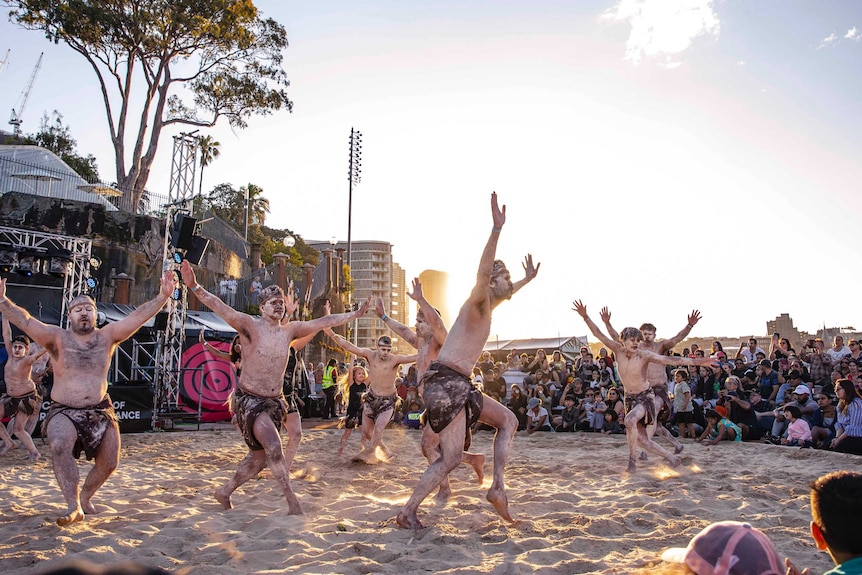 Colour photo of Thikkabilla Vibrations performing at sun down in sand circle at Dance Rites 2018.