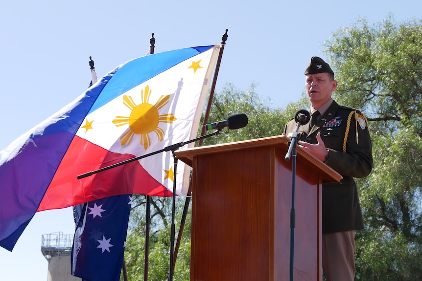 man in uniform speaking at a podium