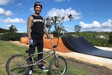 Professional Freestyle BMX rider Logan Martin in front of his backyard ramp park