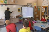 Teacher teaches children in a classroom