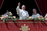 Pope Francis waves at the end of his "Urbi et Orbi" message