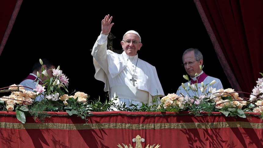 Pope Francis waves at the end of his "Urbi et Orbi" message