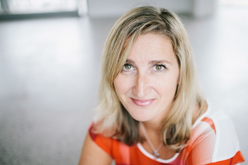 Martine Oglethorpe wearing an orange and white shirt